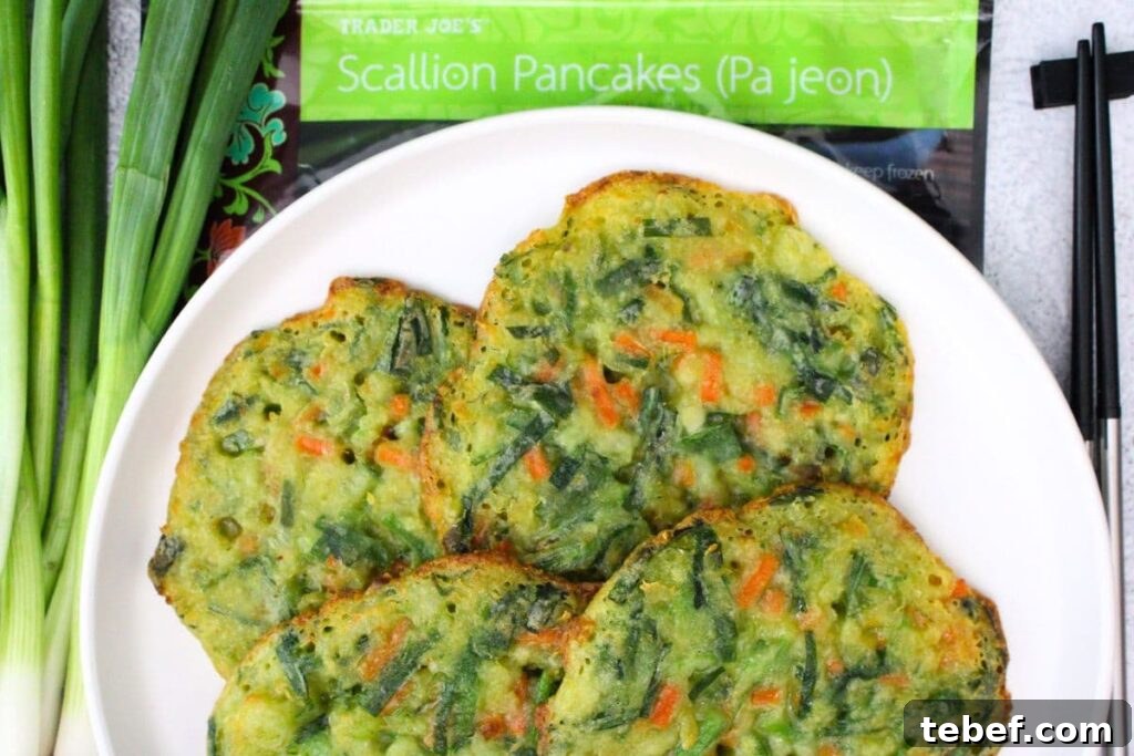 overhead view of air fryer trader joes scallion pancakes on a plate in front of packaging
