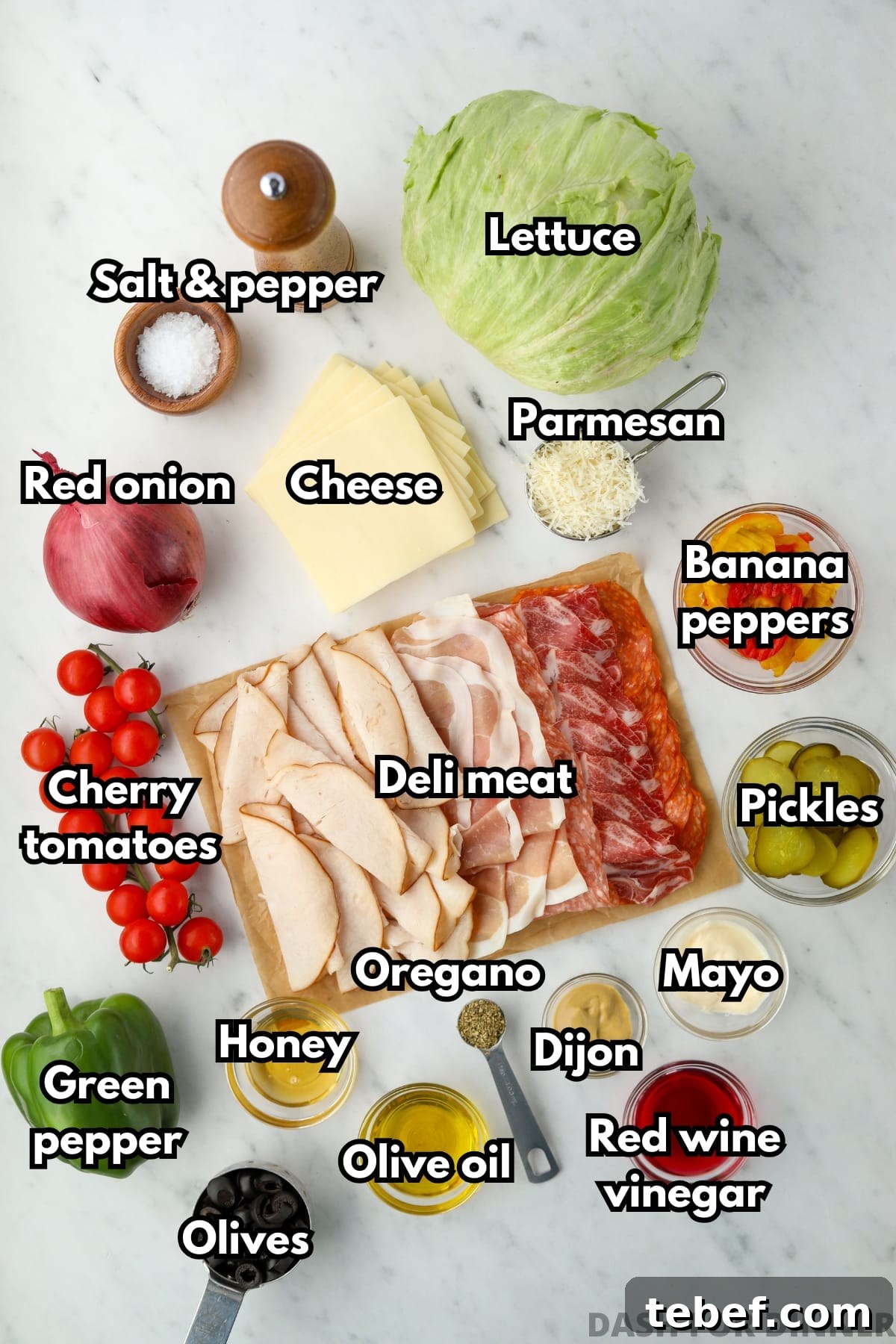 Italian Sub Sandwich Salad: Classic Deli Salad with Salami, Provolone & Italian Dressing 3 An overhead photo of ingredients, including deli meat, lettuce, and vegetables.