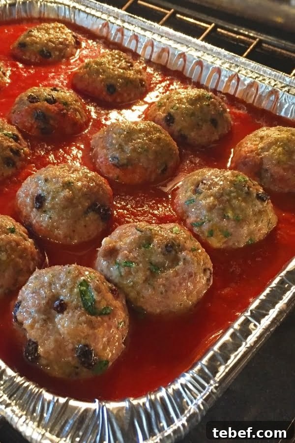 Sicilian-Style Meatballs in Fresh Basil Marinara 5 Italian recipe for balls of meat cooking in marinara sauce