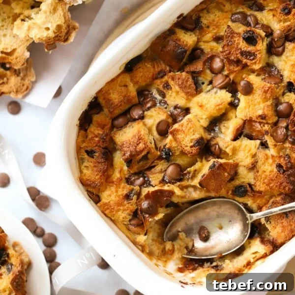 Slow Cooker Chocolate Orange Pudding Recipe 10 A baking dish filled with baked panettone bread and butter pudding, with a spoon ready to serve.
