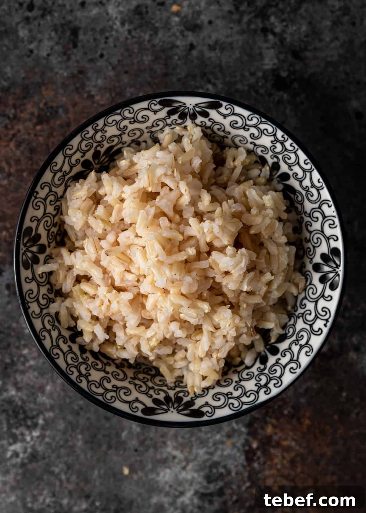 Perfectly Fluffy Brown Rice: Simple Step-by-Step Cooking Guide 8 black and white bowl with cooked brown rice