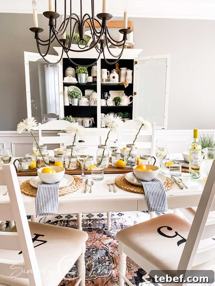 Chic Summer Dinner Party Ideas to Impress Your Guests 13 dining table set for summer dinner party with chandelier hanging above table and china hutch on wall behind table