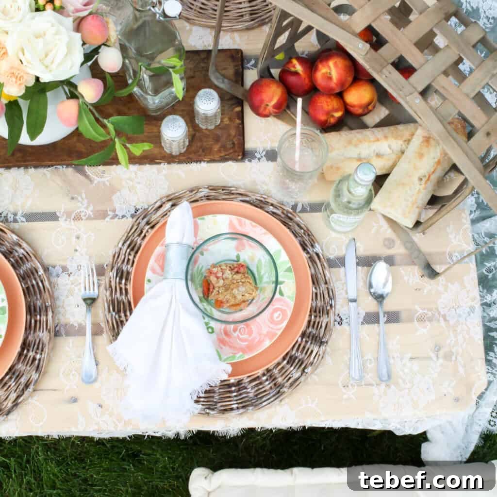 Chic Summer Dinner Party Ideas to Impress Your Guests 16 summer tablescape with basket of peaches and floral arrangement in middle of placesetting