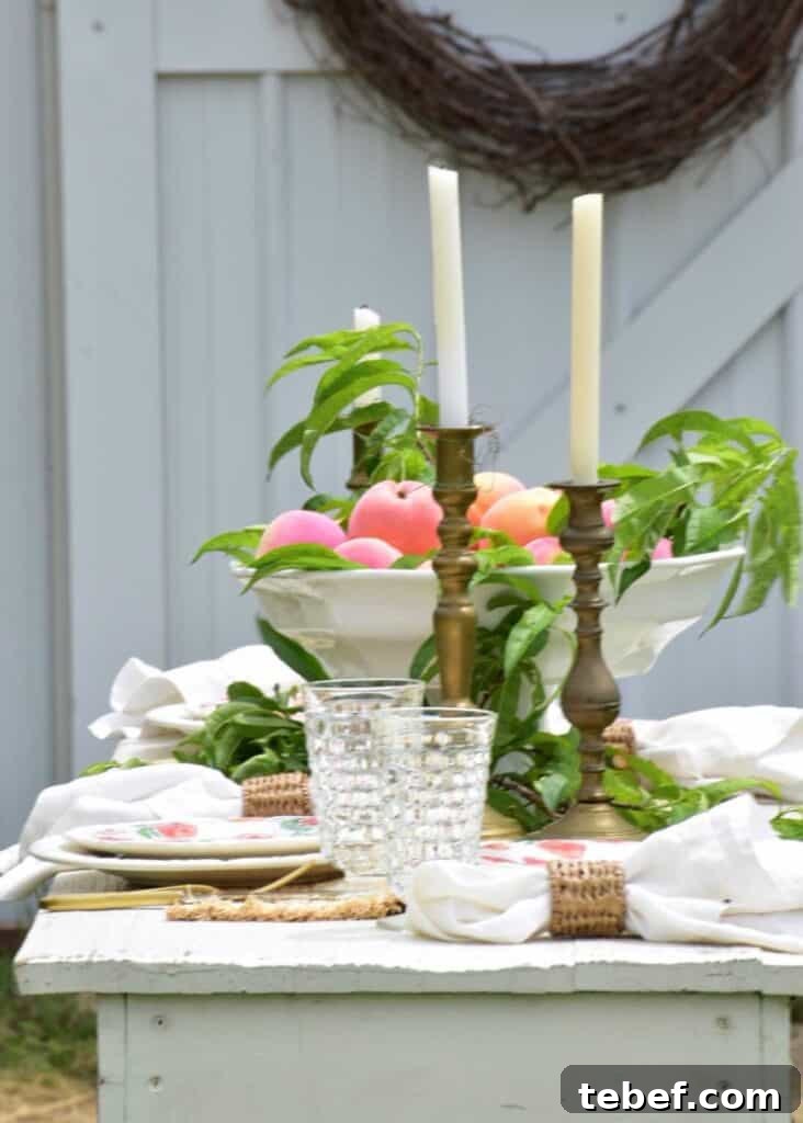 Chic Summer Dinner Party Ideas to Impress Your Guests 17 outdoor tablescape with wood candlesticks and bowl of fresh peaches in middle of placesettings