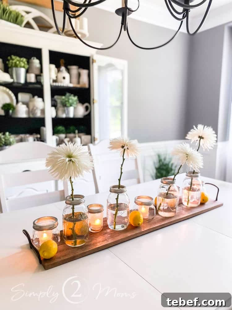 Chic Summer Dinner Party Ideas to Impress Your Guests 4 centerpiece with long wood tray filled with mason jars, flowers and candles