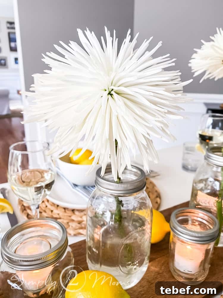 Chic Summer Dinner Party Ideas to Impress Your Guests 5 close up of white fluffy flower in mason jar on dining table