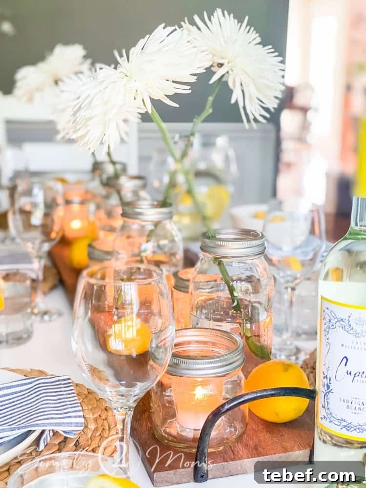 Chic Summer Dinner Party Ideas to Impress Your Guests 6 view of centerpiece made of wood tray mason jar vases and candles in mason jars