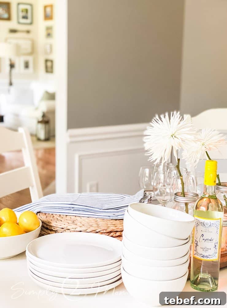 Chic Summer Dinner Party Ideas to Impress Your Guests 7 stack of plates and bowls with other items to set table for summer dinner party