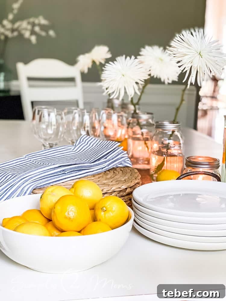 Chic Summer Dinner Party Ideas to Impress Your Guests 8 bowl of lemons on end of table with stack of plates and napkins beside it