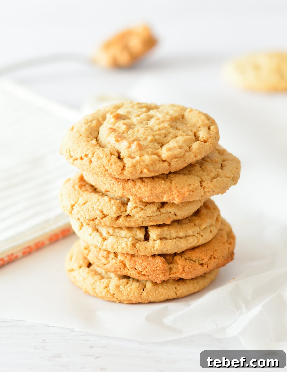 Irresistibly Chewy Peanut Butter Cookie Recipe 12 a stack of peanut butter cookies.