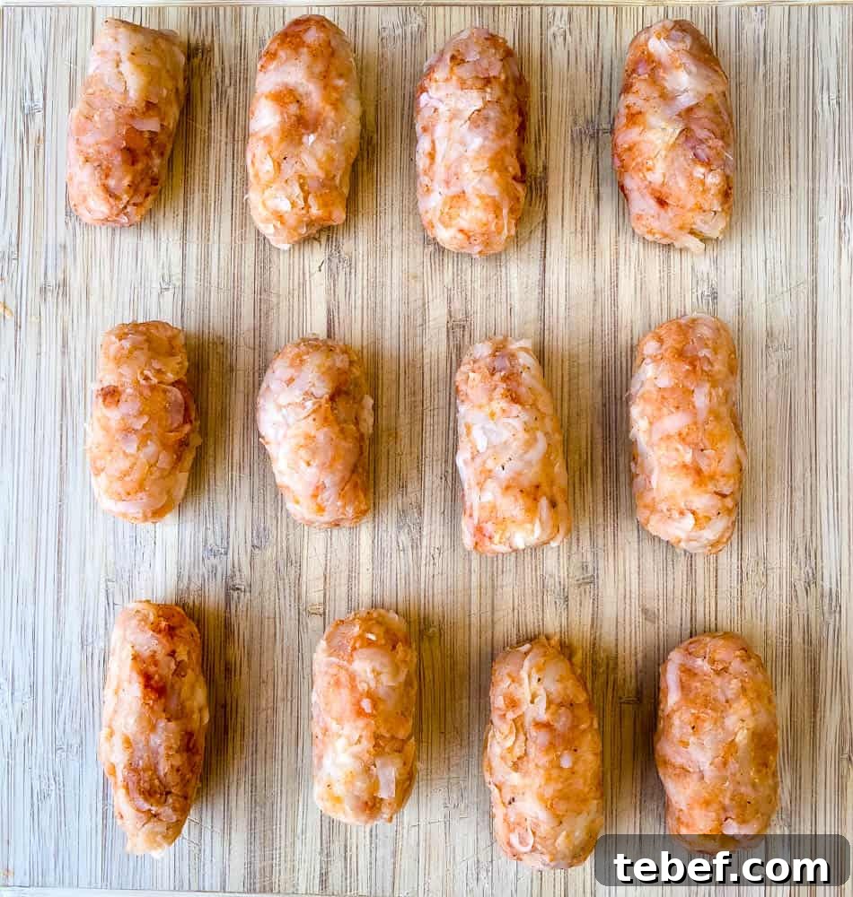 Crispy Air Fryer Tater Tots: Perfectly Golden Every Time 6 uncooked air fryer tater tots on a cutting board