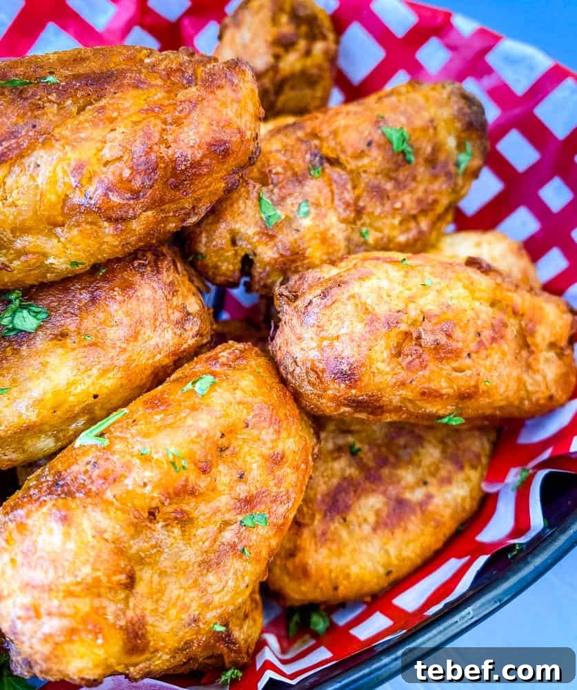Crispy Air Fryer Tater Tots: Perfectly Golden Every Time 9 air fryer tater tots in a red and white basket with ketchup and chipotle mayo