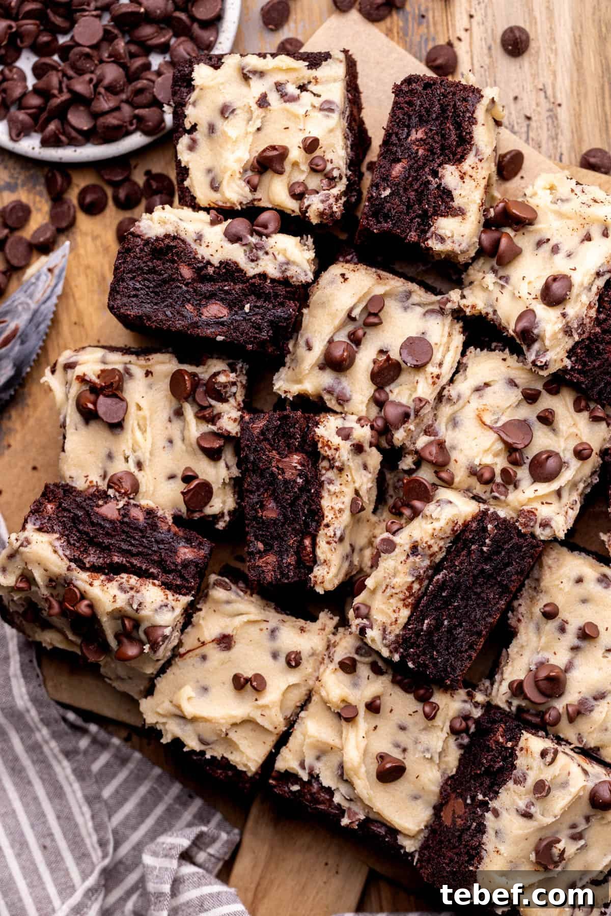 Cookie Dough Brownies Recipe: Fudgy Brownies with Edible Cookie Dough 3 Cookie dough brownies on a wood platter.