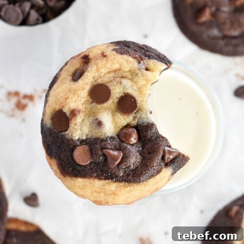 marble cookie with bite out missing on glass of milk.
