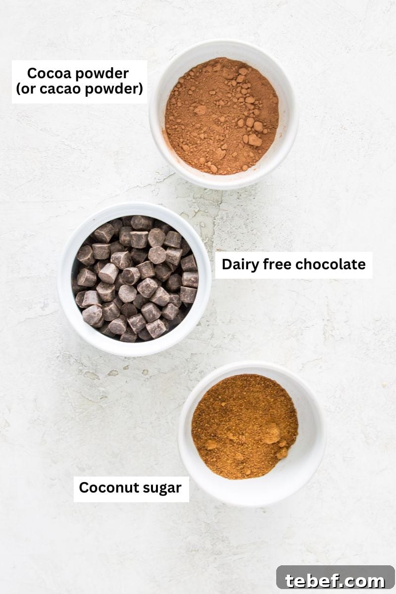 Vegan Hot Chocolate Bombs: Dairy-Free Paleo Recipe and How-To 2 Three bowls filled with different ingredients including cocoa powder, chocolate chips and coconut sugar.