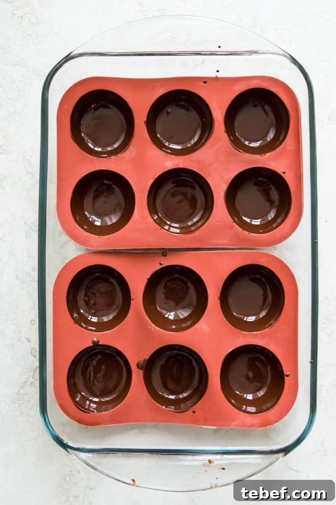 Vegan Hot Chocolate Bombs: Dairy-Free Paleo Recipe and How-To 4 Melted chocolate in sphere silicone molds.