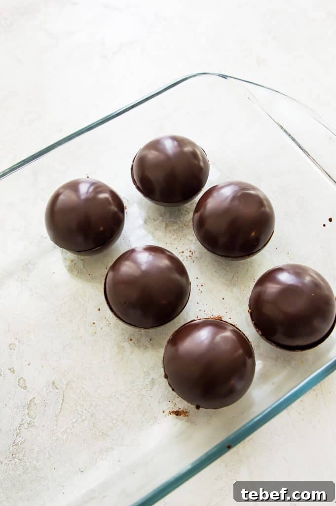 Vegan Hot Chocolate Bombs: Dairy-Free Paleo Recipe and How-To 8 A glass baking dish filled with hot chocolate bombs.