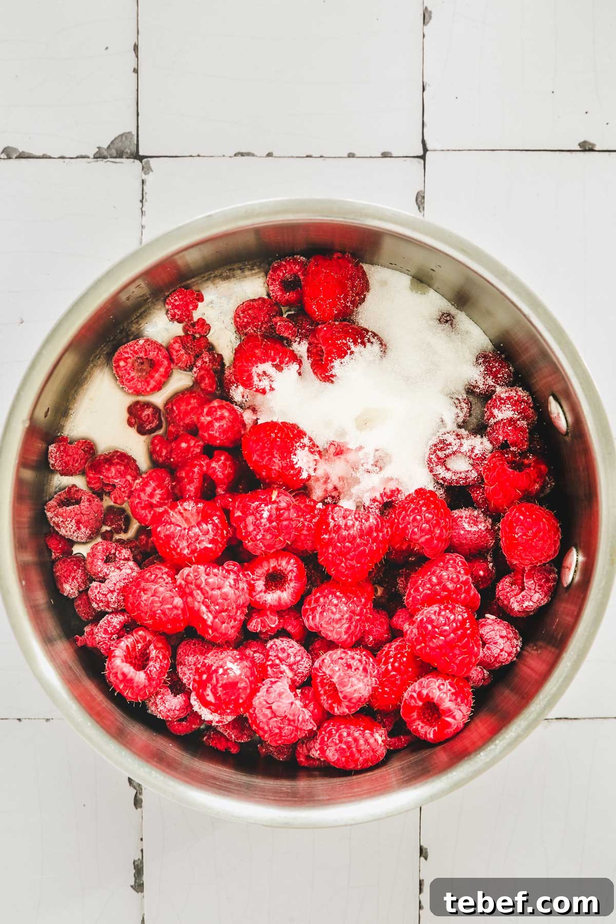 Raspberry Mascarpone Layer Cake with Fresh Cream Filling 7 Homemade raspberry compote cooking in a saucepan