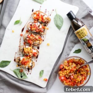 Whipped Ricotta Crostini toasts with Roasted Red Pepper Salsa and balsamic drizzle on a party platter
