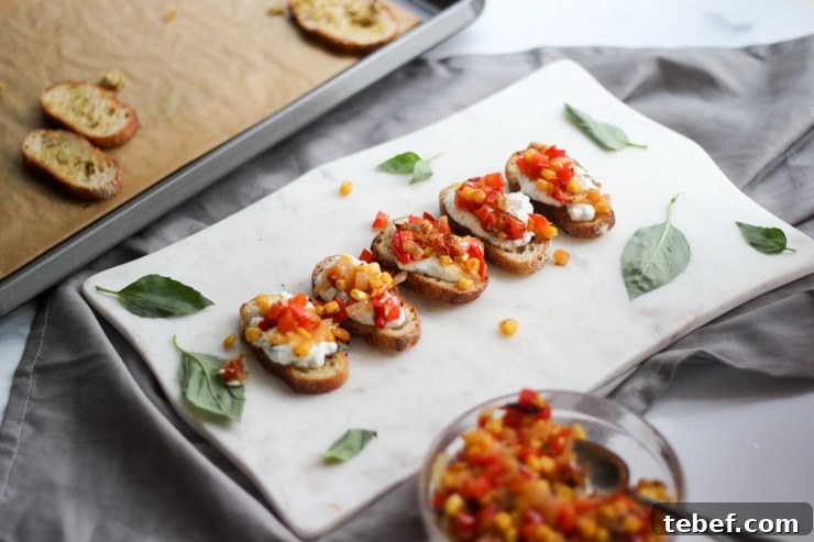ricotta crostini topped with roasted red pepper salsa on a party tray