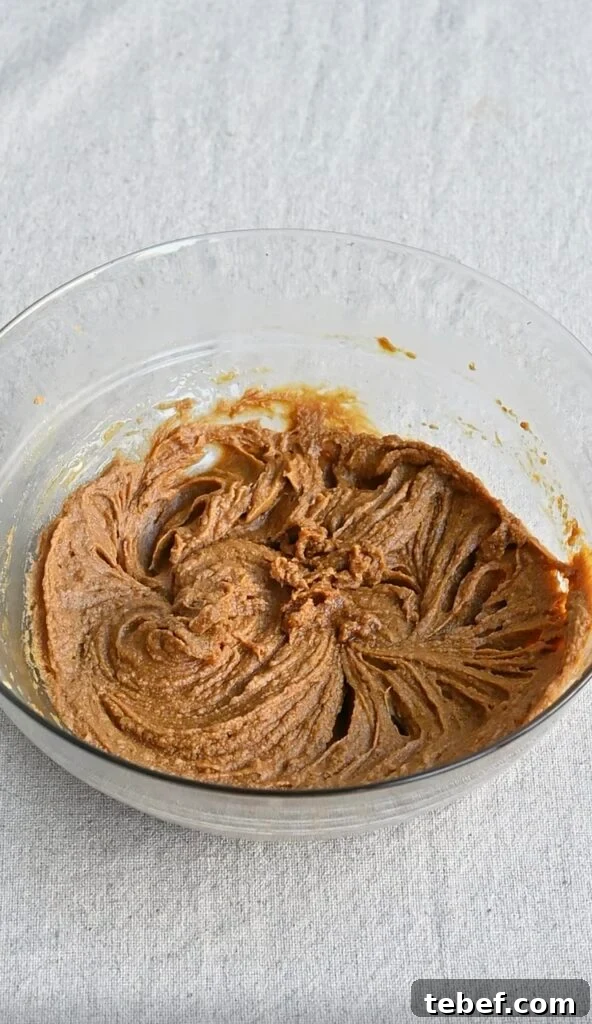 Chewy Chocolate Gingerbread Cookies Recipe for Holiday Baking 6 brown sugar, butter, egg and molasses mixture in a bowl.