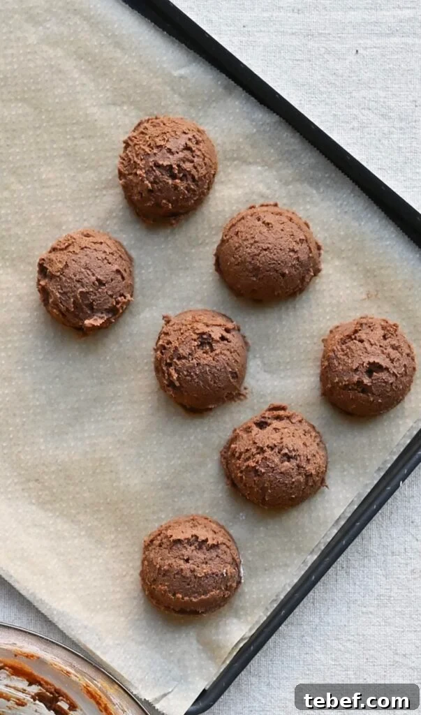 Chewy Chocolate Gingerbread Cookies Recipe for Holiday Baking 8 Overhead of chocolate cookie dough balls on a baking sheet.