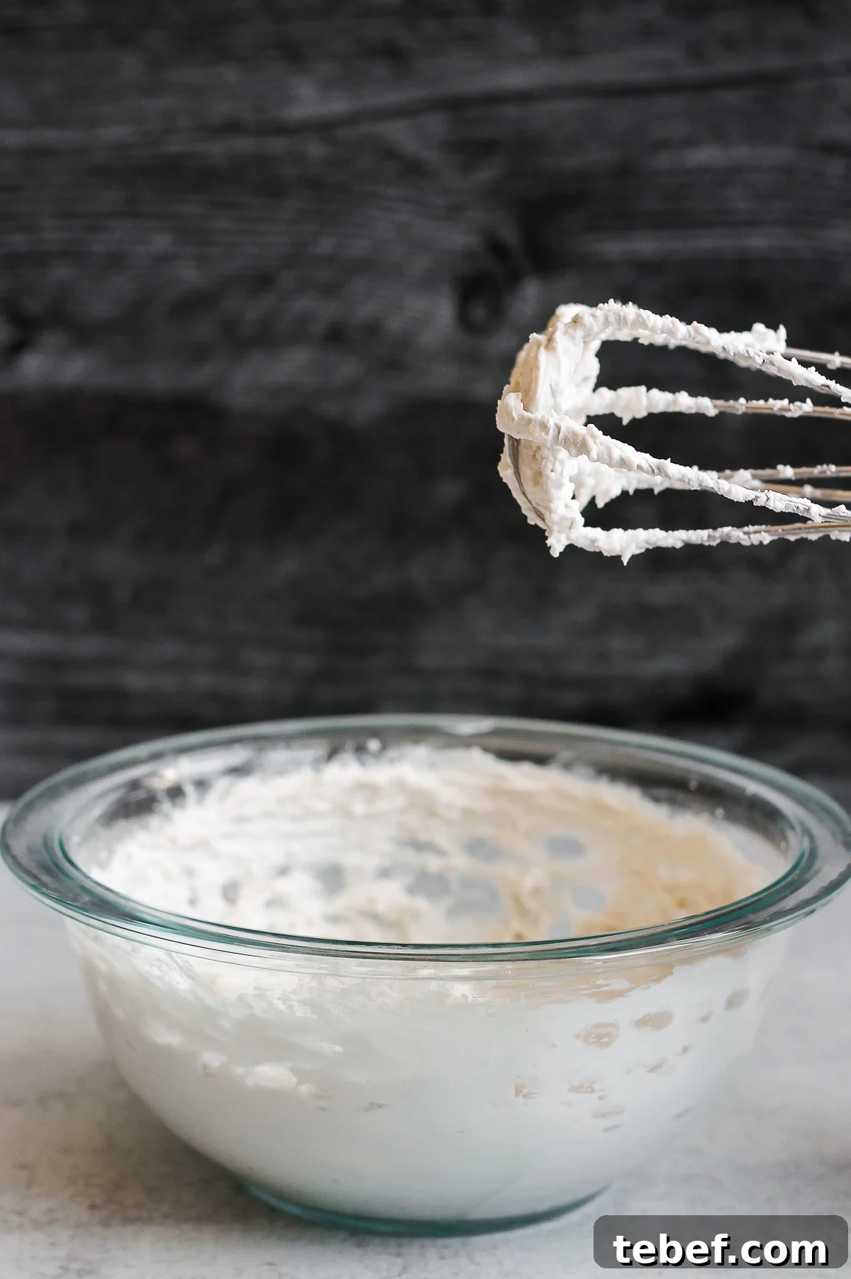 Coconut Whipped Cream Recipe: Light, Dairy-Free Topping in Minutes 2 electric beater with whipped coconut cream standing over mixing bowl