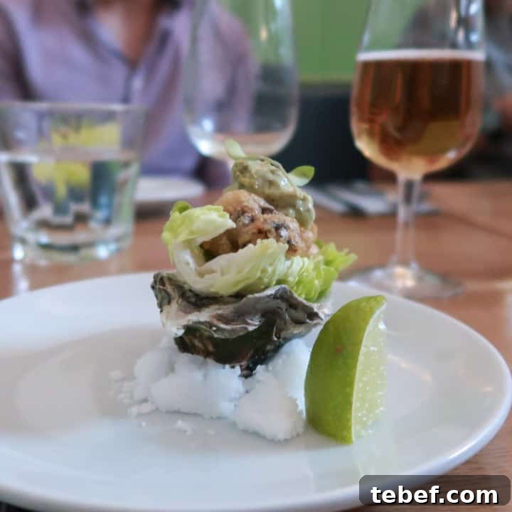 Porthleven Food Festival — Cornwall’s 2019 Seafood & Street Food Guide 6 tempura oyster in a baby gem leaf, sat inside an oyster shell, balanced on a pile of salt at the Porthleven Food Festival 2019