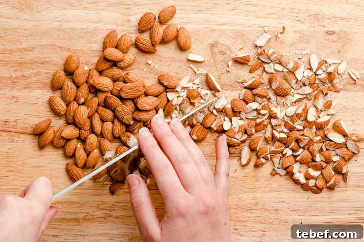 knife chopping almonds into small pieces
