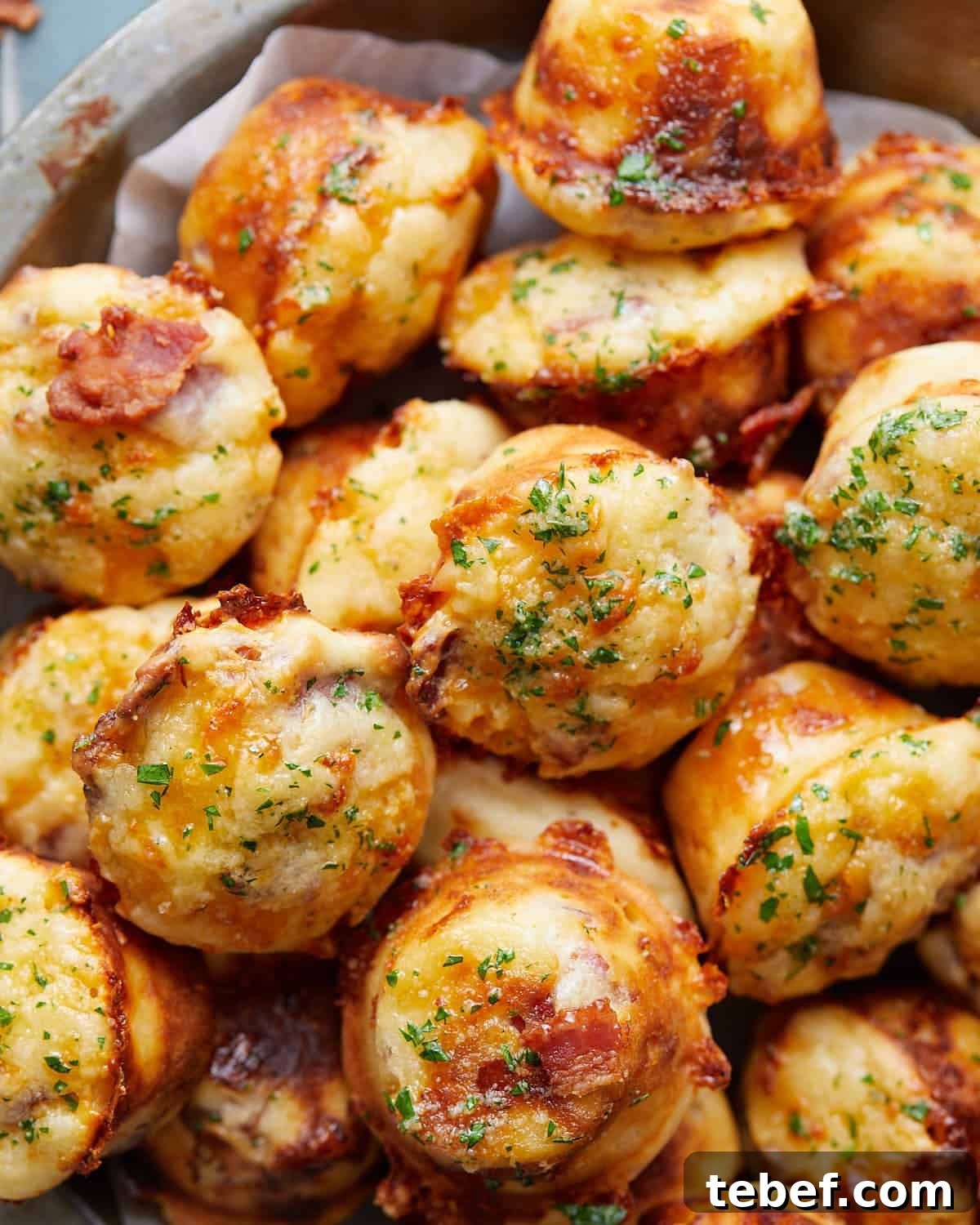 Savory Bacon and Cheddar Muffins for Breakfast or Brunch 2 Overhead image of bacon and cheddar cheese muffins with garnish.