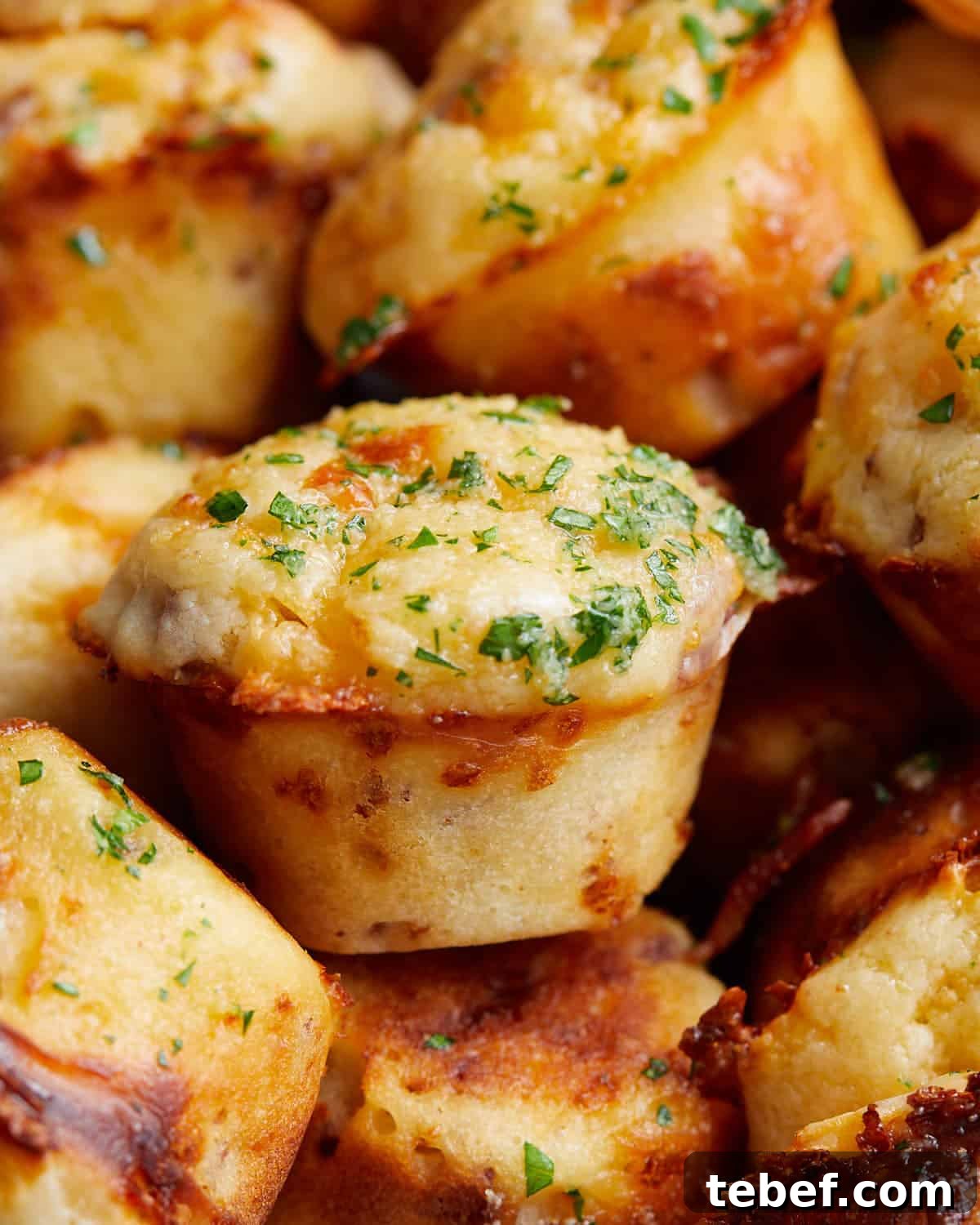 Savory Bacon and Cheddar Muffins for Breakfast or Brunch 5 Up close image of bacon and cheddar cheese muffin with garnish.