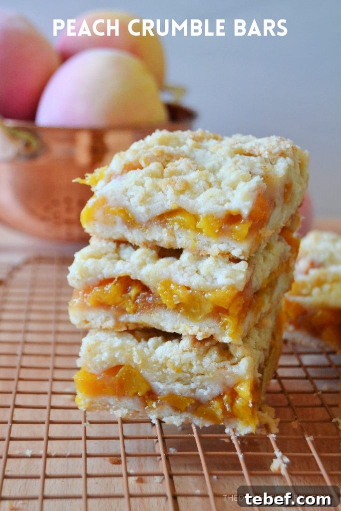 Peach Crumble Bars Recipe — Sweet Summer Dessert Bars 2 a stack of three peach crumble bars on a wire rack
