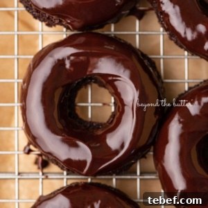 Homemade Baked Chocolate Donuts Recipe for Moist, Rich Donuts 13 Homemade baked chocolate donuts topped with chocolate ganache glaze on a wire cooling rack.