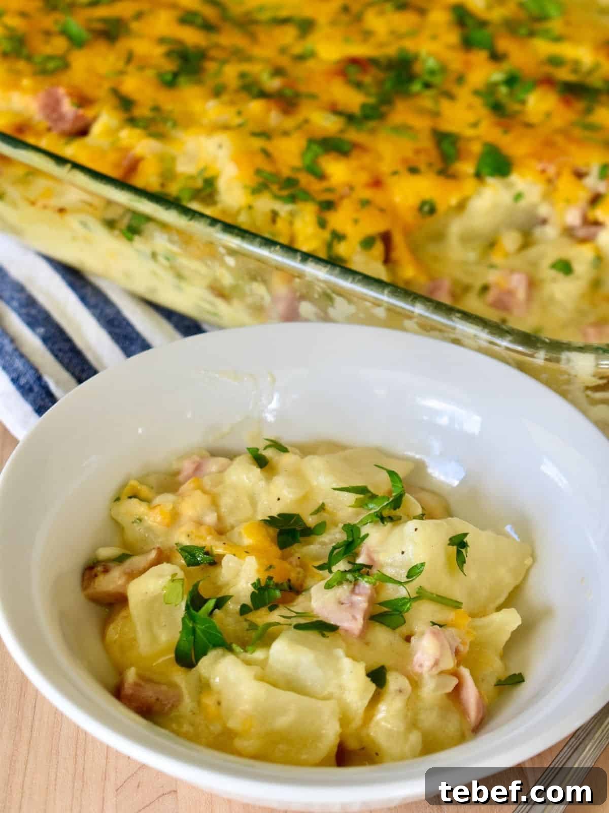 Cheesy Ham and Potato Casserole Recipe for Leftover Ham 9 Cheesy ham and potato casserole in a white bowl.