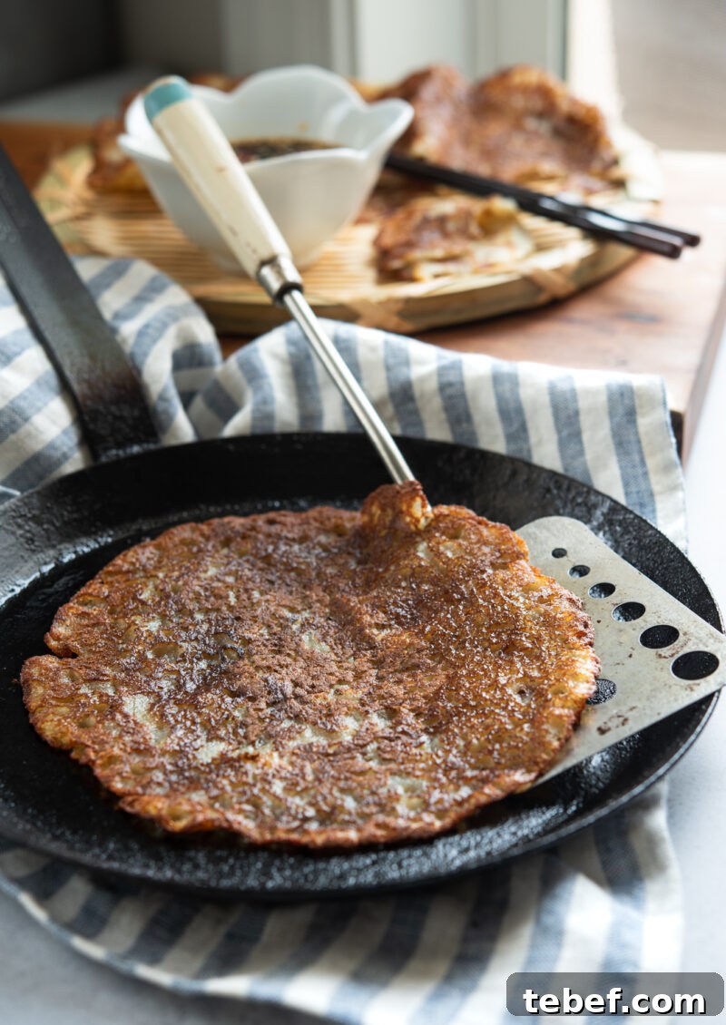 Crispy Korean Potato Pancakes (Gamja-Jeon) — Authentic Recipe 2 Korean potato pancake (gamja-jeon) sizzling in a skillet until golden and crisp