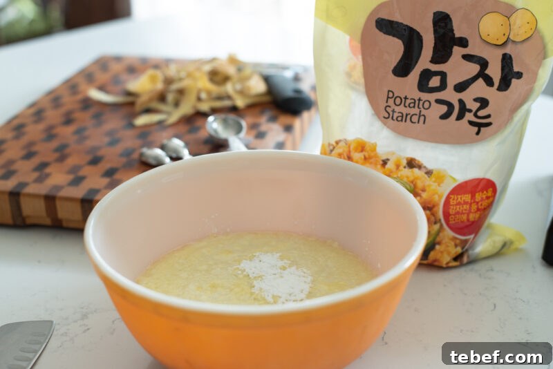 Crispy Korean Potato Pancakes (Gamja-Jeon) — Authentic Recipe 7 Potato purée mixed with potato starch in a bowl.