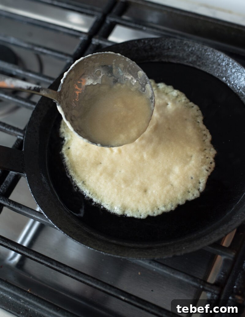 Crispy Korean Potato Pancakes (Gamja-Jeon) — Authentic Recipe 8 Potato pancake batter poured into a hot skillet to cook Korean gamja-jeon