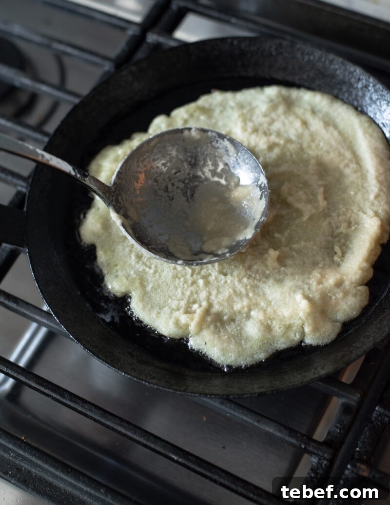 Crispy Korean Potato Pancakes (Gamja-Jeon) — Authentic Recipe 9 preading potato pancake batter in a skillet to form thin Korean gamja-jeon