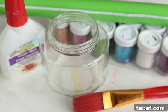 Mess-Free Glitter Tea Light Lanterns for Sparkling Home Decor 4 glass jar, glitter, paintbrush, glue, contact paper