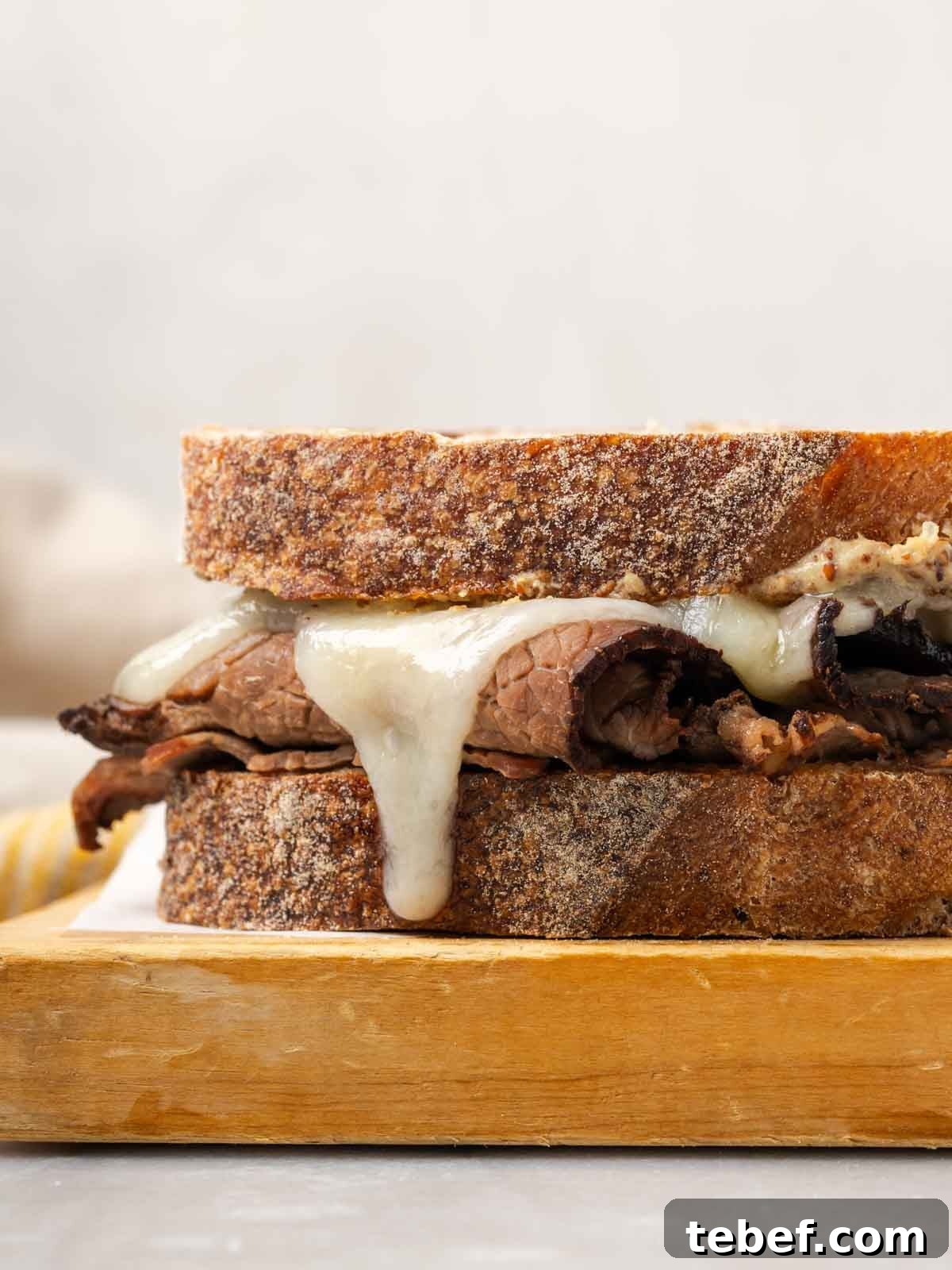 melted cheese on roast beef sandwich.