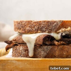 melted cheese on roast beef sandwich.