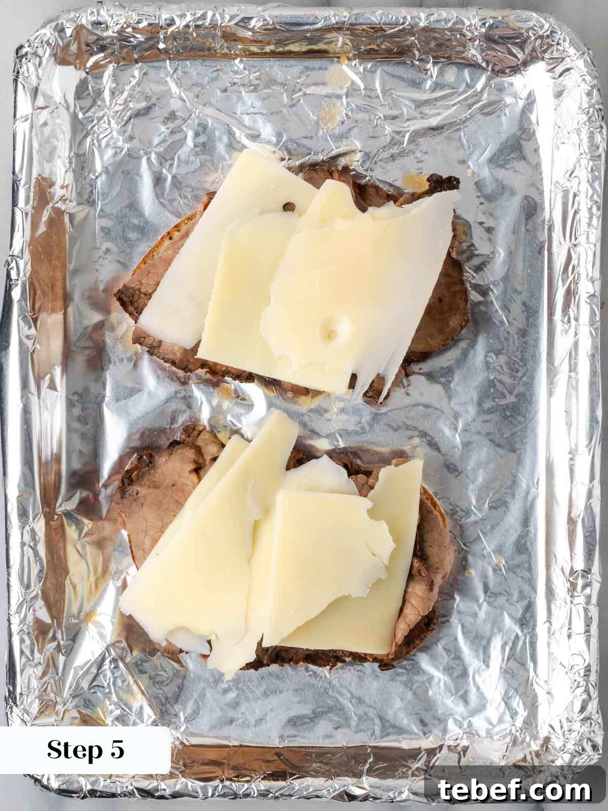 ingredients on openfaced sandwiches on foil.