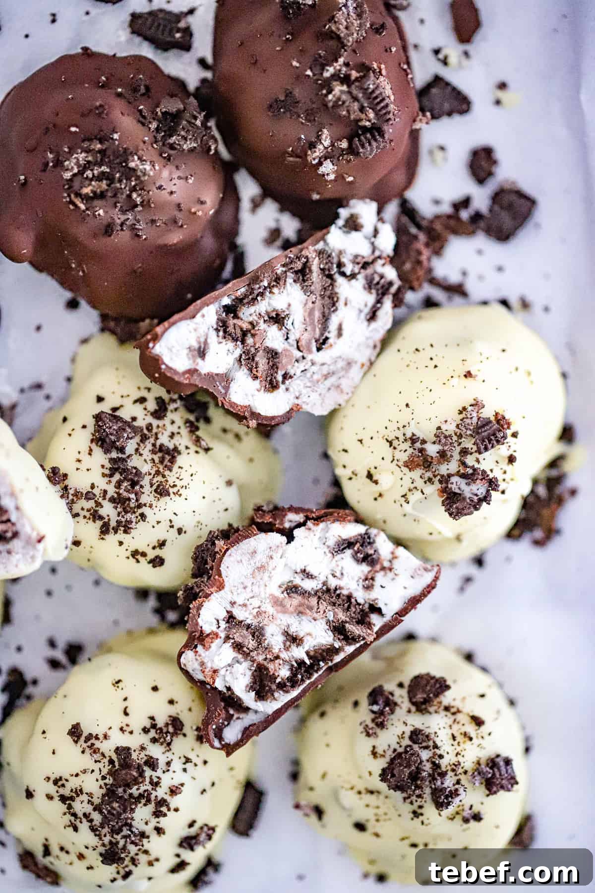 Frozen Oreo yogurt bites dipped in white chocolate with cookie crumbs on top