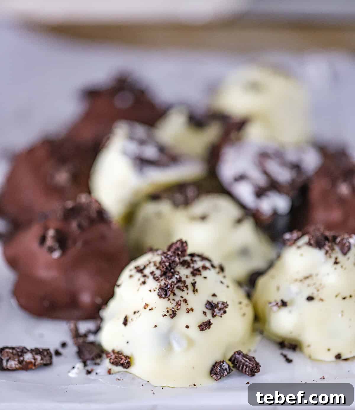 Frozen yogurt bites with Oreo pieces before dipping in chocolate