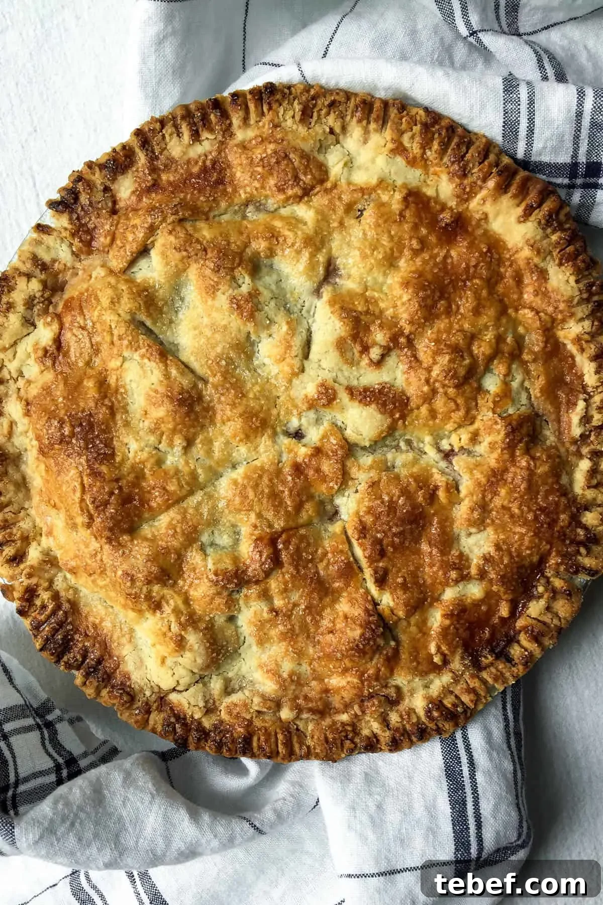 Classic Homemade Cherry Pie Recipe with Flaky Crust 7 Overhead close up of baked homemade cherry pie, showing browned flaky crust.