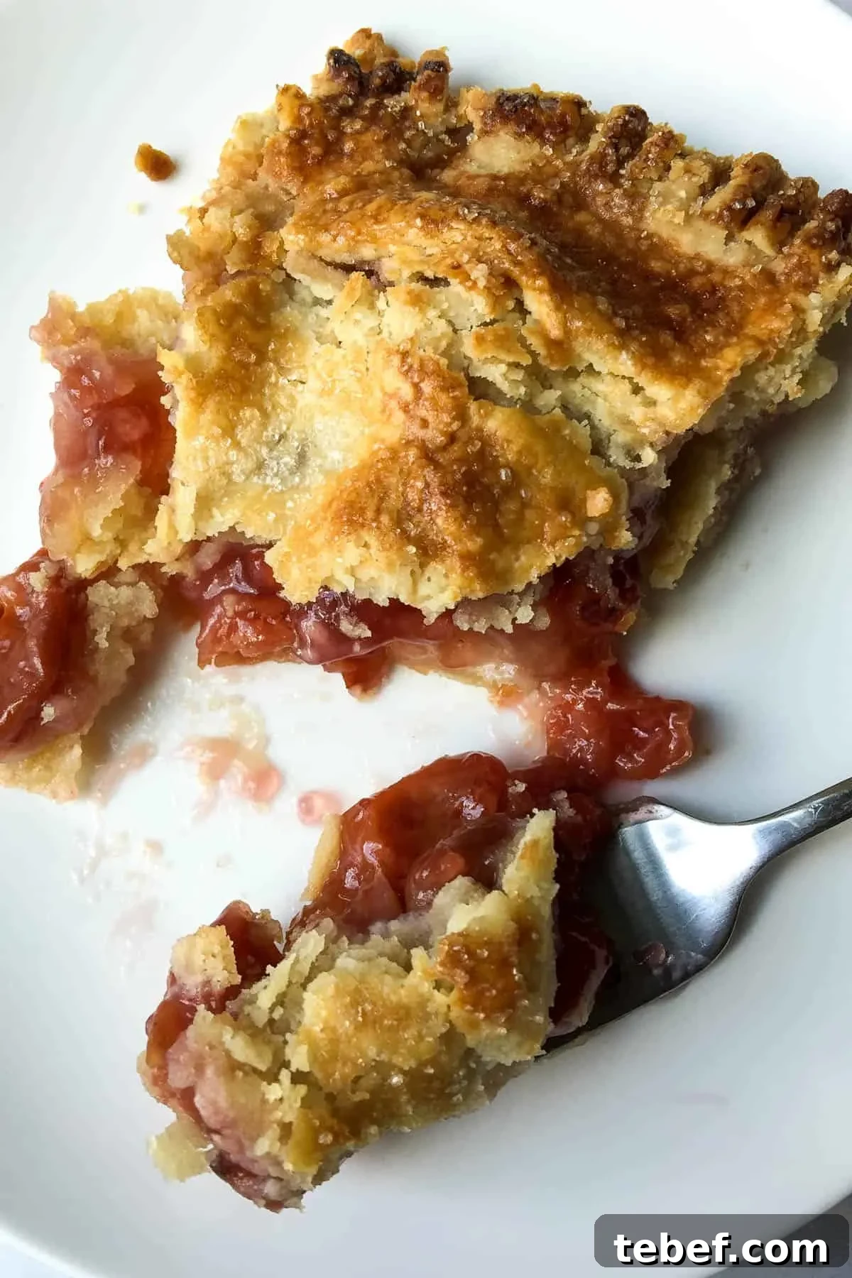 Classic Homemade Cherry Pie Recipe with Flaky Crust 8 Cherry Pie on plate cut with a forkful.