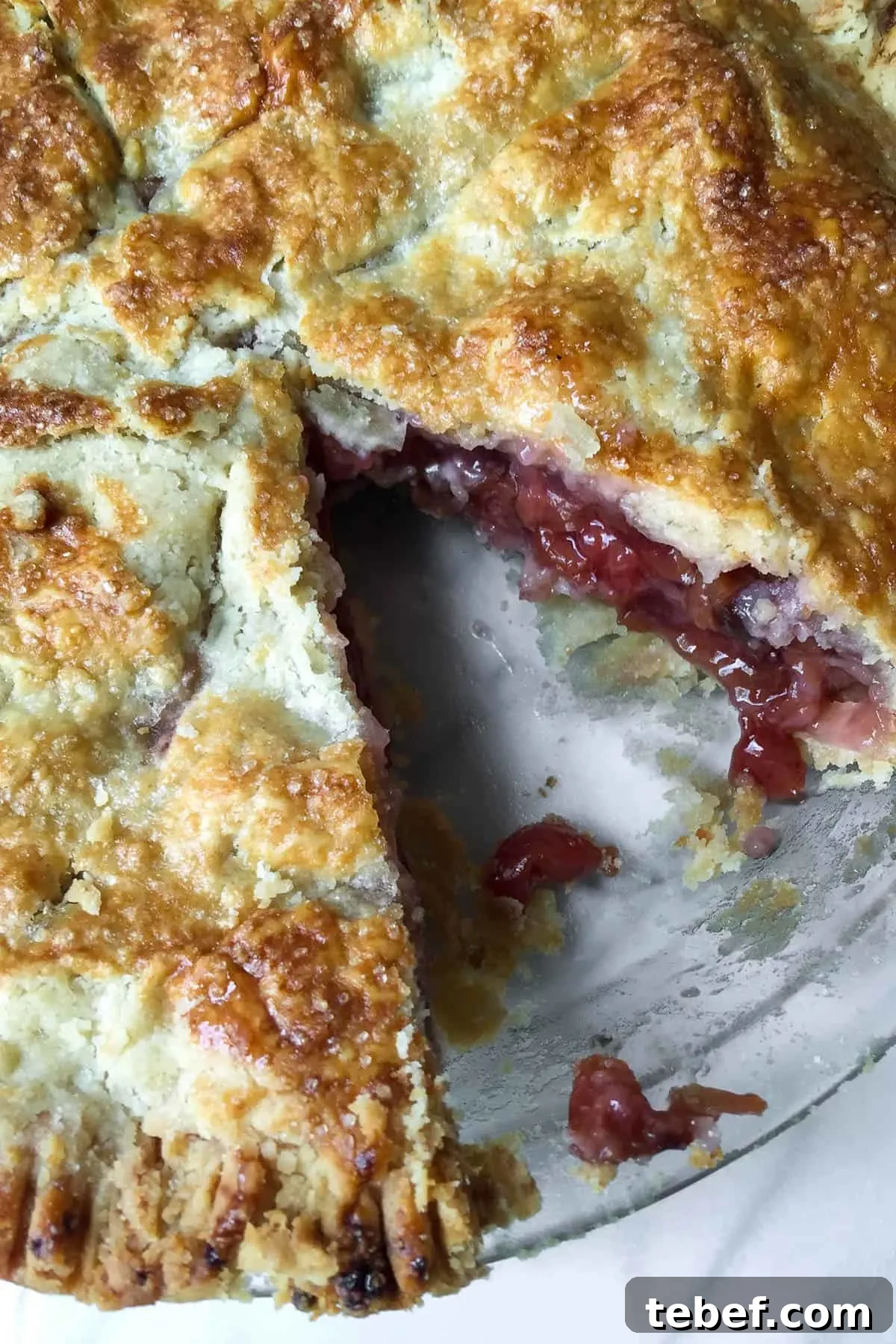 Classic Homemade Cherry Pie Recipe with Flaky Crust 3 Close up of cherry pie with a piece cut out.
