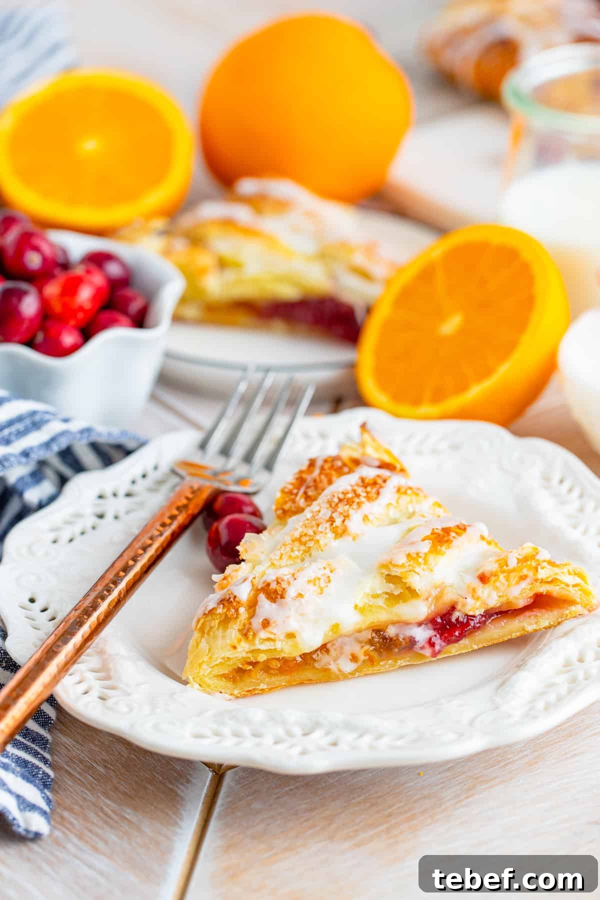 Cranberry Orange Sweet Braid Recipe — Flaky Holiday Pastry 2 Cranberry Orange Braid slice on white plate