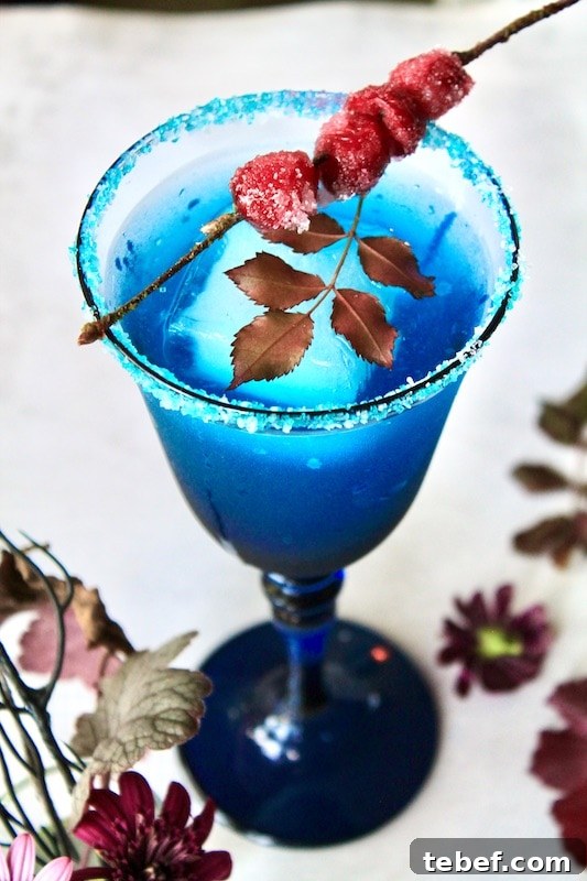 add light rum lemon juice simple syrup apple cranberry juice and blue curacao to cocktail shaker with ice