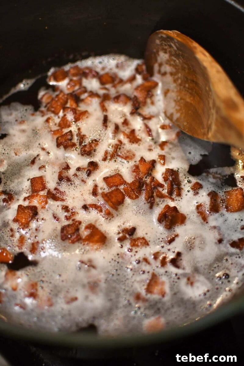 Creamy Beer Cheese Soup Recipe with Bacon and Pretzel Croutons 4 Crisping bacon in the bottom of a pot.